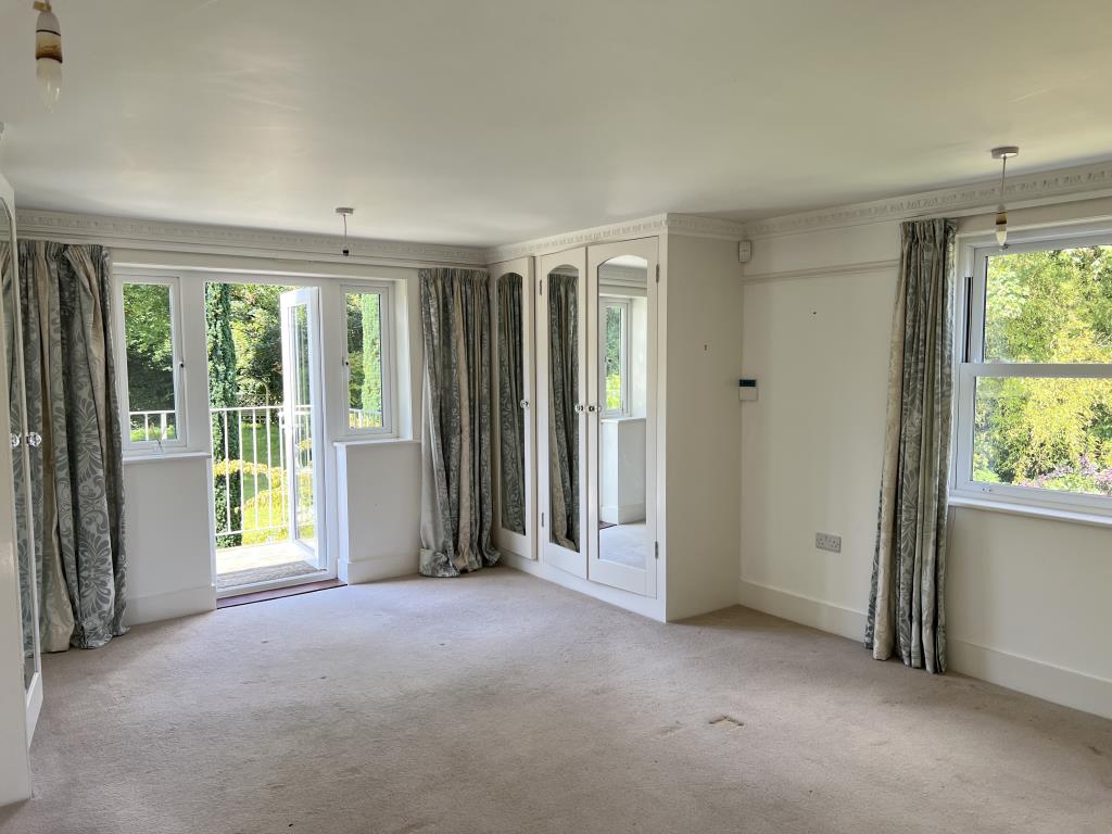 Lot: 159 - SUBSTANTIAL THREE-BEDROOM EXTENDED COTTAGE WITH SEPARATE ANNEXE - Main bedroom with view out to balcony